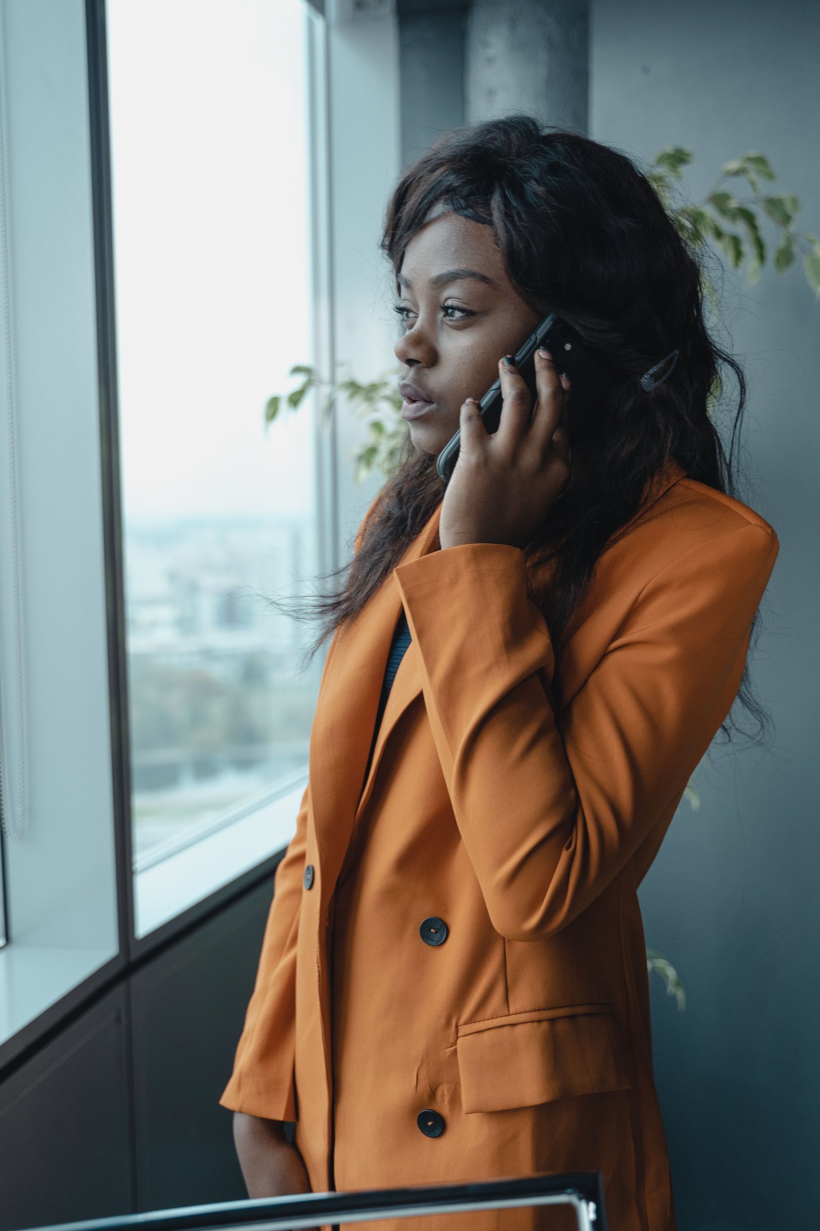 An independent recruiter on a call by the window of her office